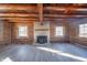 Spacious living area featuring a wood burning stove and log walls at 4298 W 300 N, Anderson, IN 46011