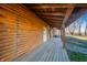 Wooden porch with log cabin walls and view of backyard at 4298 W 300 N, Anderson, IN 46011