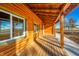 Relaxing covered porch with wooden beams and log cabin exterior at 4298 W 300 N, Anderson, IN 46011