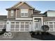 Two-story house with taupe siding, white trim, and a three-car garage at 581 Beehler Dr, Whiteland, IN 46184