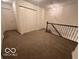 Upstairs hallway with carpet, doors, and staircase at 581 Beehler Dr, Whiteland, IN 46184