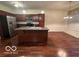 Kitchen with island, stainless steel appliances, and dark wood cabinets at 581 Beehler Dr, Whiteland, IN 46184