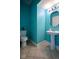Small bathroom with pedestal sink and teal walls at 8231 Golden Ridge Ln, Indianapolis, IN 46237