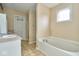 Bathroom with double vanity, bathtub and tile floor at 8231 Golden Ridge Ln, Indianapolis, IN 46237