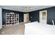 Bedroom with white bed, built-in bookcase and access to hallway at 8231 Golden Ridge Ln, Indianapolis, IN 46237