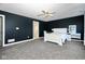 Bright bedroom with white sleigh bed, built-in shelves, and access to bathroom at 8231 Golden Ridge Ln, Indianapolis, IN 46237