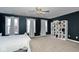 Bedroom with white bed, built-in bookcase, and plenty of natural light at 8231 Golden Ridge Ln, Indianapolis, IN 46237