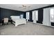 Spacious bedroom with white sleigh bed, desk, and ample natural light at 8231 Golden Ridge Ln, Indianapolis, IN 46237