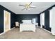 Primary bedroom with white sleigh bed and ensuite bathroom with a bathtub at 8231 Golden Ridge Ln, Indianapolis, IN 46237