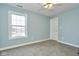 Small bedroom with light blue walls and a large window at 8231 Golden Ridge Ln, Indianapolis, IN 46237