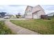 Two-story house with beige siding, two-car garage, and a side yard at 8231 Golden Ridge Ln, Indianapolis, IN 46237