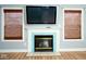 Fireplace with light blue tile and wood mantel at 8231 Golden Ridge Ln, Indianapolis, IN 46237