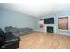 Living room featuring hardwood floors, fireplace, and large TV at 8231 Golden Ridge Ln, Indianapolis, IN 46237