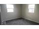 Bright bedroom with two windows and grey carpet at 1320 Smokey Rd, Martinsville, IN 46151