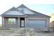 New construction home with gray brick and a two-car garage at 1399 Foxtail Ln, Greenwood, IN 46143