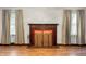 Classic wooden fireplace with brass screen at 1826 Maple St, Columbus, IN 47201