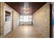 Bright sunroom featuring brick walls and light wood flooring at 1826 Maple St, Columbus, IN 47201