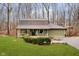 Green house with brown roof, attached garage, and landscaped yard at 1850 White Oak W Ln, Martinsville, IN 46151