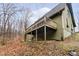 Green house exterior with wooden deck and stairs leading down at 1850 White Oak W Ln, Martinsville, IN 46151