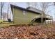 Green house exterior with wooden deck and stairs leading down at 1850 White Oak W Ln, Martinsville, IN 46151