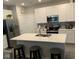 Kitchen island with seating and white quartz countertops at 20176 Fenside Xing, Westfield, IN 46074