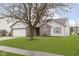 House exterior featuring a well-maintained lawn and two-car garage at 2368 Black Gold Dr, Indianapolis, IN 46234