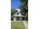 Charming white house with a porch and well-maintained lawn at 3938 E 31St St, Indianapolis, IN 46218