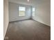 Spacious bedroom with neutral carpeting and large windows at 5601 Tart Blvd, Indianapolis, IN 46239