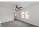 Bedroom with ceiling fan, grey carpet, and an open door at 60 E Pleasant Run Parkway North N Dr, Indianapolis, IN 46225