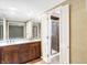 Bathroom with double vanity, marble countertop, and walk-in shower at 6337 Cardinal Ln, Indianapolis, IN 46220