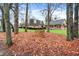 Brick home nestled among trees with a brick column in the foreground at 6337 Cardinal Ln, Indianapolis, IN 46220