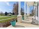 Large front porch with white columns and turquoise planters at 6818 W Willow Grove Dr, New Palestine, IN 46163