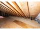 Unfinished attic space with wood framing and plywood flooring at 6822 Bruton Dr, Indianapolis, IN 46256