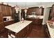 Island kitchen with granite countertops, breakfast bar, and hardwood floors at 10566 Morningtide Cir, Fishers, IN 46038