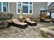 Comfortable patio with lounge chairs and fire pit area at 10566 Morningtide Cir, Fishers, IN 46038