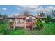 Backyard with deck, sunroom, and landscaping at 120 S Elma St, Anderson, IN 46012