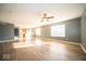 Open living room with gray walls, hardwood floors, and a view of the kitchen at 1225 Fiesta Dr, Franklin, IN 46131