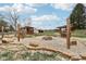 Landscaped backyard with firepit, wood storage, and string lights at 12389 N Navajo Ct, Camby, IN 46113