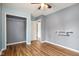 Bedroom with gray and light blue walls, wood-look flooring, ceiling fan and closet at 12389 N Navajo Ct, Camby, IN 46113