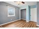 Bedroom with gray and light blue walls, wood-look flooring, ceiling fan and closet at 12389 N Navajo Ct, Camby, IN 46113