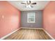 Bedroom with gray and coral walls, wood-look flooring and ceiling fan at 12389 N Navajo Ct, Camby, IN 46113