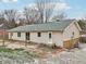 Tan house exterior with green roof and small patio at 12389 N Navajo Ct, Camby, IN 46113