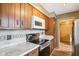 Cozy kitchen with wood cabinets, and a view into the adjoining living room at 12389 N Navajo Ct, Camby, IN 46113