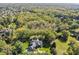 An aerial view showcasing the home's location in a lush, wooded neighborhood at 13829 N Gray Rd, Carmel, IN 46033