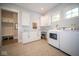 Laundry room with white cabinets, washer, and dryer at 13829 N Gray Rd, Carmel, IN 46033