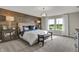 King-size bedroom with wood-paneled accent wall and large windows at 1468 Covington Blvd, Franklin, IN 46131