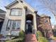 Stone and brick home with a grand entrance and manicured landscaping at 14865 Braemar E Ave, Noblesville, IN 46062