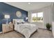 Bedroom with a white bed, blue accent pillows, and a dark blue accent wall at 1503 Covington Blvd, Franklin, IN 46131