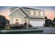 Two-story house with light beige and brown siding, brick accents, and a two-car garage at 1503 Covington Blvd, Franklin, IN 46131