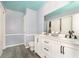 Bathroom with double vanity and white cabinets at 1535 N Glen Arm Rd, Indianapolis, IN 46214